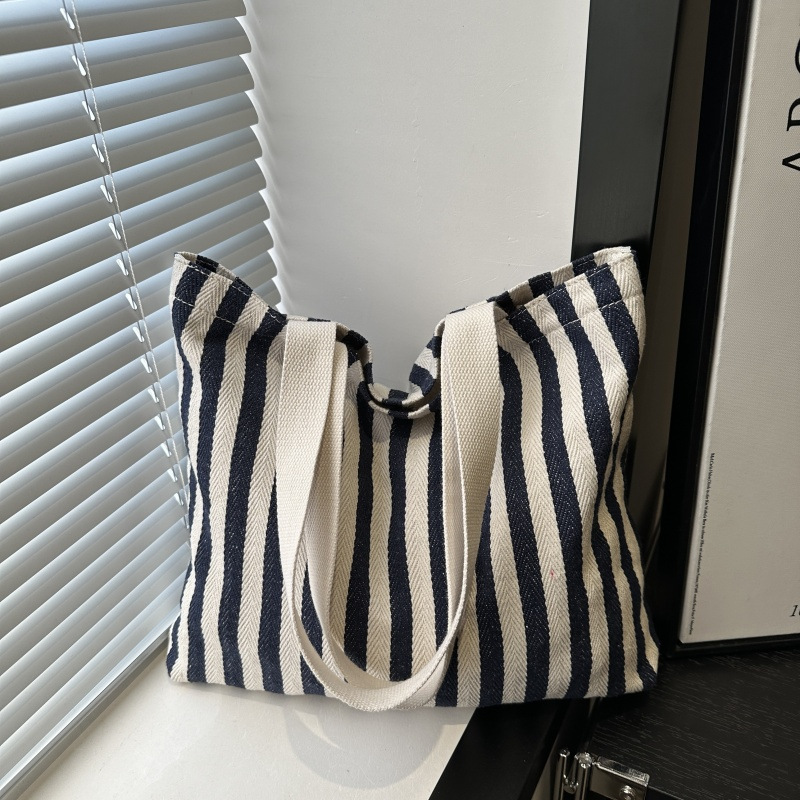 The new cross-border vertical striped commuter tote bag, hand-held shoulder bag, is fashionable and has a large capacity. It features an InS-style simple letter sail undefined