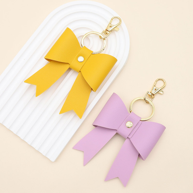 新商品のシンプルなPU革の蝶結びの形のキーホルダーのストラップは卸売りして国境を越えて百合をかけることができます。|undefined