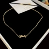 Golden necklace with letters