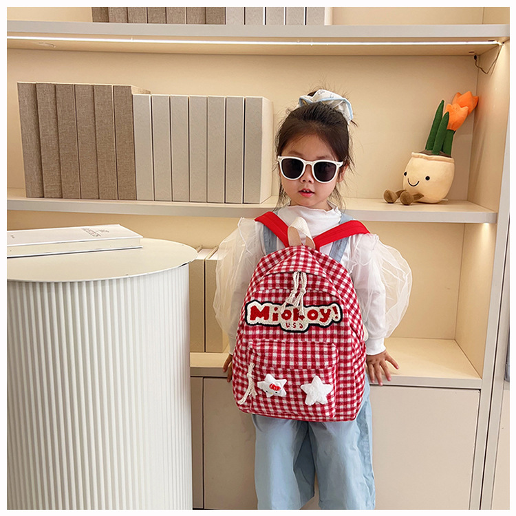 The large-capacity red woolen checkered backpack for primary and secondary school students is a unique and versatile choice. It's a trend for girls to carry backpacks during their leisure trips undefined