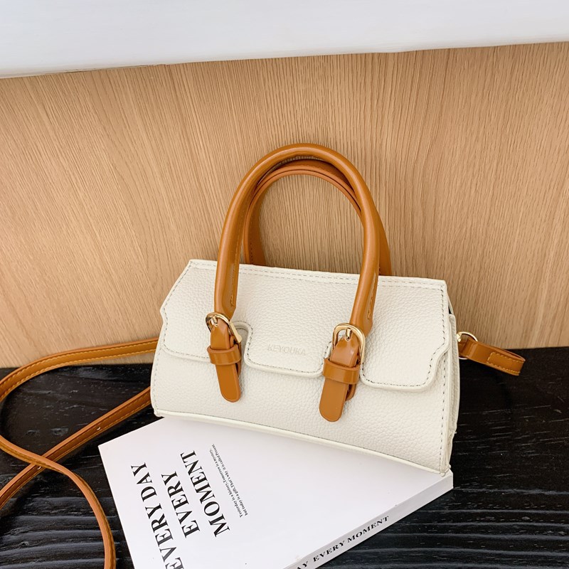 2025 nuevo bolso para niños de comercio exterior, bolso de niña popular de moda coreana, bolso de mensajero para bebé de color sólido de estilo extranjero