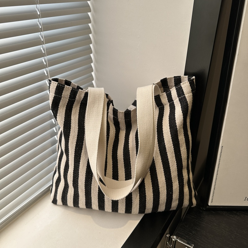 The new cross-border vertical striped commuter tote bag, hand-held shoulder bag, is fashionable and has a large capacity. It features an InS-style simple letter sail undefined