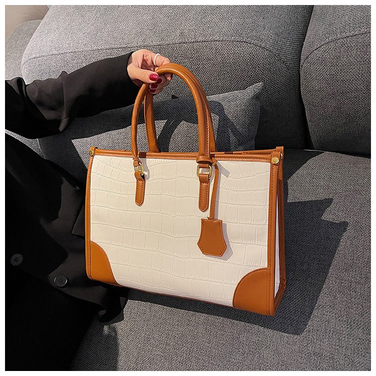 Bolso Tote portátil transfronterizo de gran capacidad para mujer 2025 nuevo modelo retro patrón de piedra contraste bolso de mensajero de hombro de viajero
