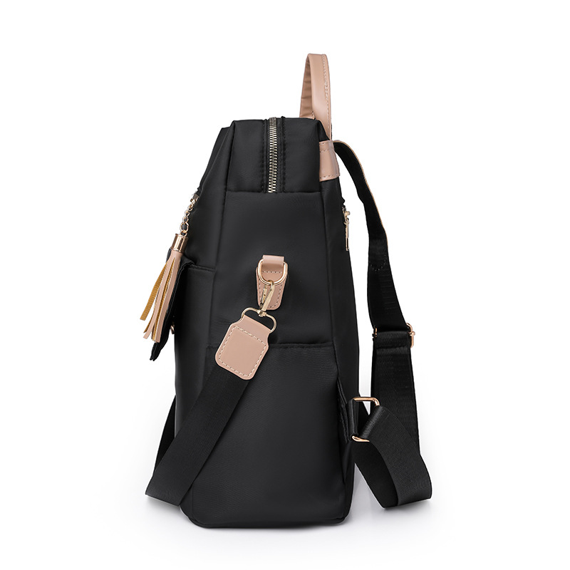 Fábrica al por mayor 2023 nueva versión coreana de la mochila de nailon para mujer moda literaria color de contraste viaje mochila de doble uso marea