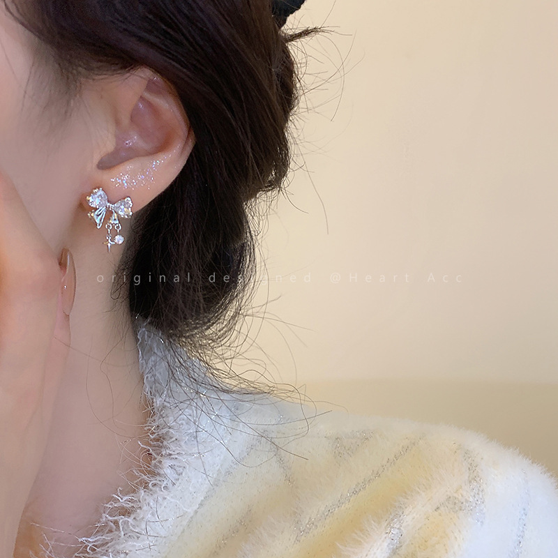 Small design fashionable elegant earrings with bow with zircon