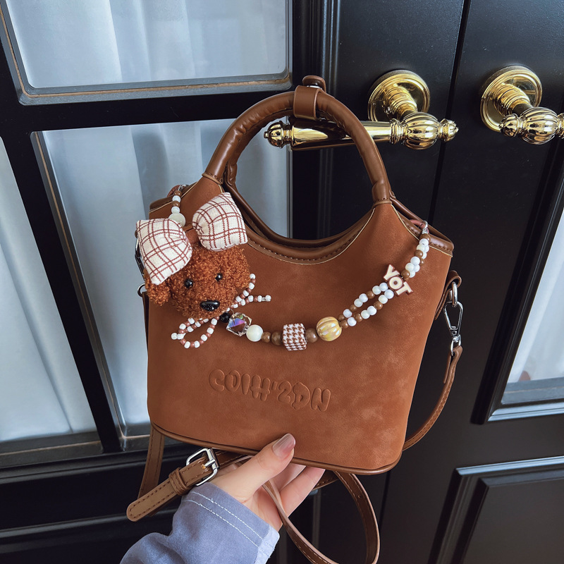 Otoño 2025 nuevo perro cuentas bolso de cubo bolso de viaje femenino estilo coreano retro mochila de hombro esmerilado