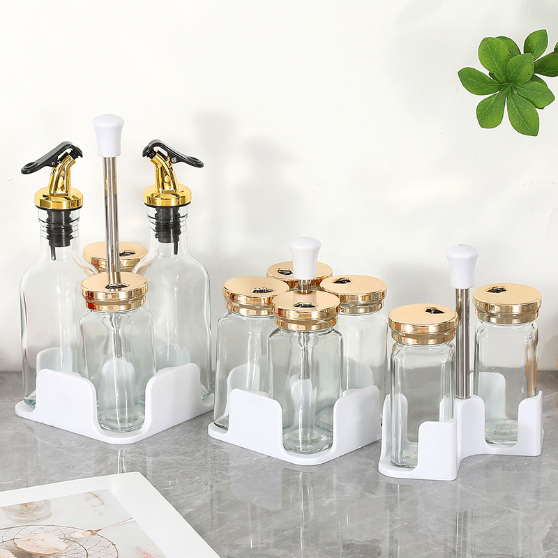 Botella cuadrada de lujo ligera de cuatro piezas Botella de condimento de vidrio de cocina Olla de aceite Tanque de sal a prueba de humedad Tarro de condimento Botella giratoria