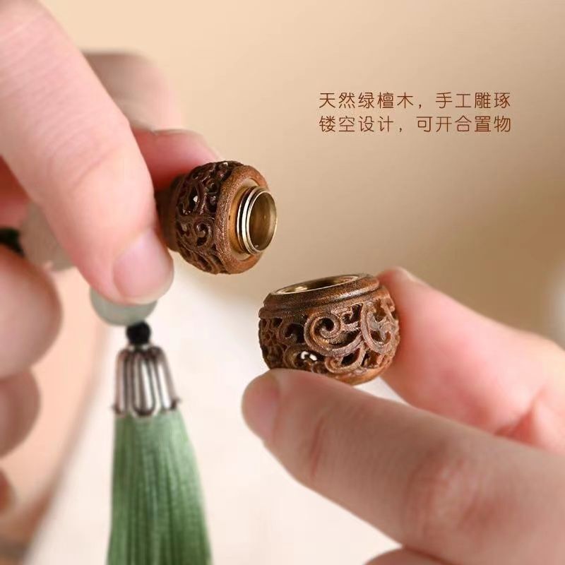 Green sandalwood exquisite hollow-out sachet ball keychain Xizang incense portable pendant wearing ancient style can open mobile phone chain Green sandalwood exquisite hollow-out sachet ball keychain Xizang incense portable pendant wearing ancient style can open mobile phone chain