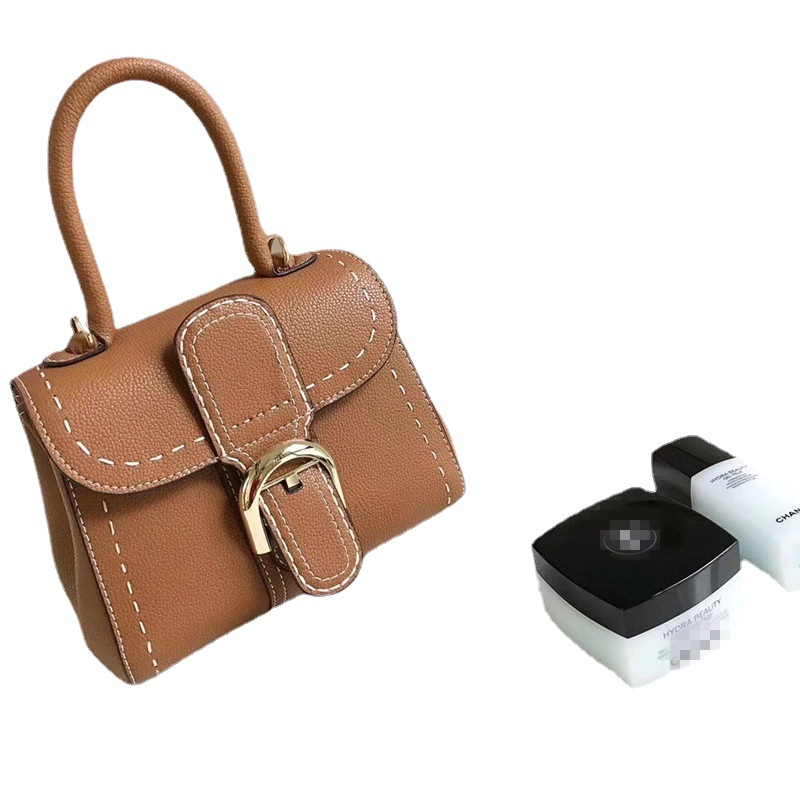 Bolso de mano con hebilla de herradura, modelo nuevo de 2025, bandolera de cuero de vaca granulado de primera capa, bolso de sillín informal y versátil.