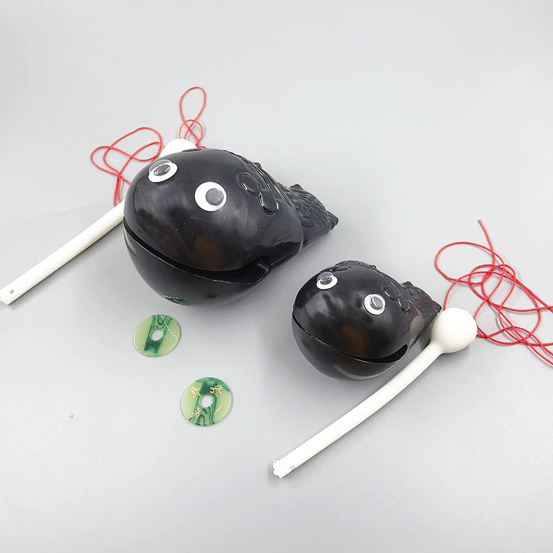 Woodfish percussion toy, plastic, 2" or 3" (6×5×5 cm / 10×8×8 cm), with striker and strap