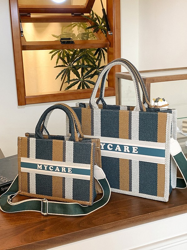 Bolso portátil de alta gama a rayas con sentido al por mayor transfronterizo logotipo personalizado nuevo casual todo-fósforo bolso de mensajero de gran capacidad