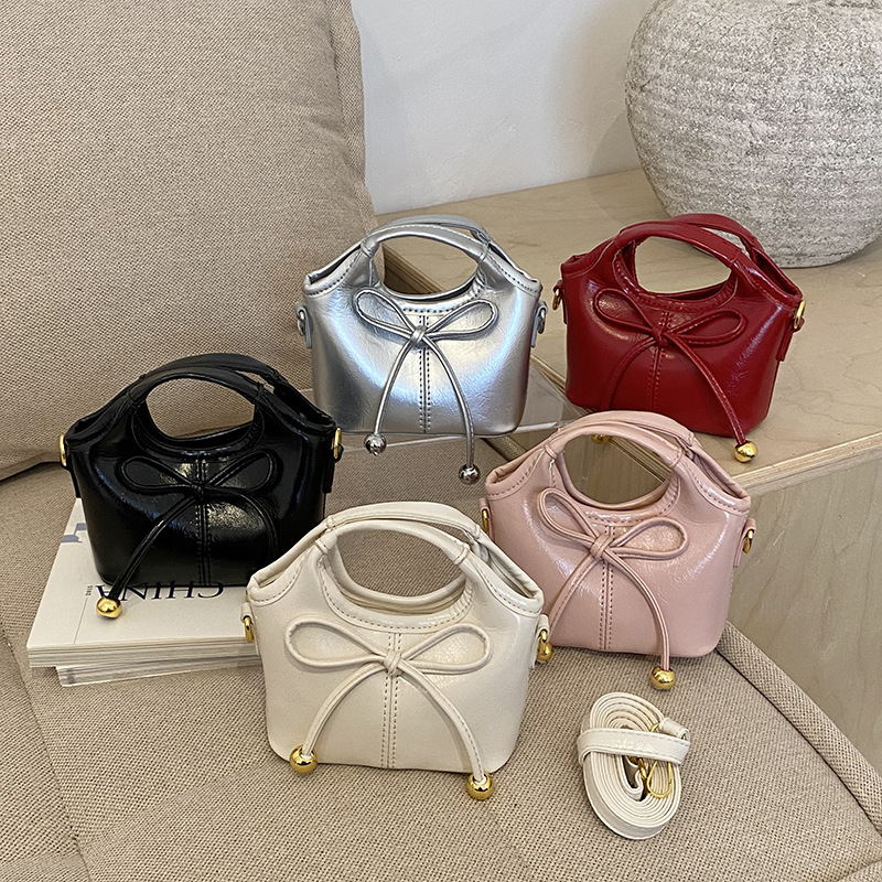 Bolsas infantiles transfronterizas de moda coreana de color sólido, bolsas de mano de chicas, mini bolsas de cestas de arco lindas