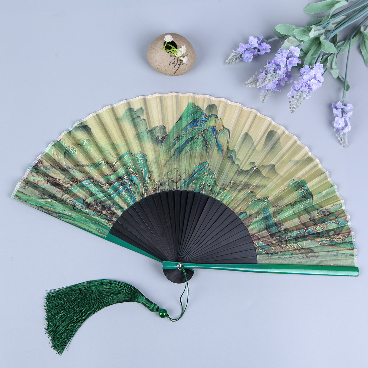 A folding fan with the theme of "A Thousand Li of Rivers and Mountains" in traditional Chinese style, featuring silk material, ancient garden aesthetics, and a portable design, perfect for traditional Chinese dance.