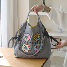 2025春季新款日系尼龙万针刺绣包包时尚通勤大容量学院风单肩购物