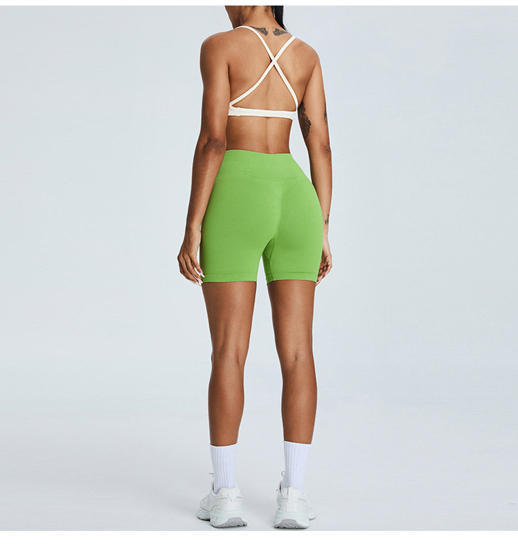 Nuevo traje de yoga sin costuras europeo y americano, pantalones cortos de yoga de cadera de melocotón para mujer, traje deportivo de carrera de espalda cruzada