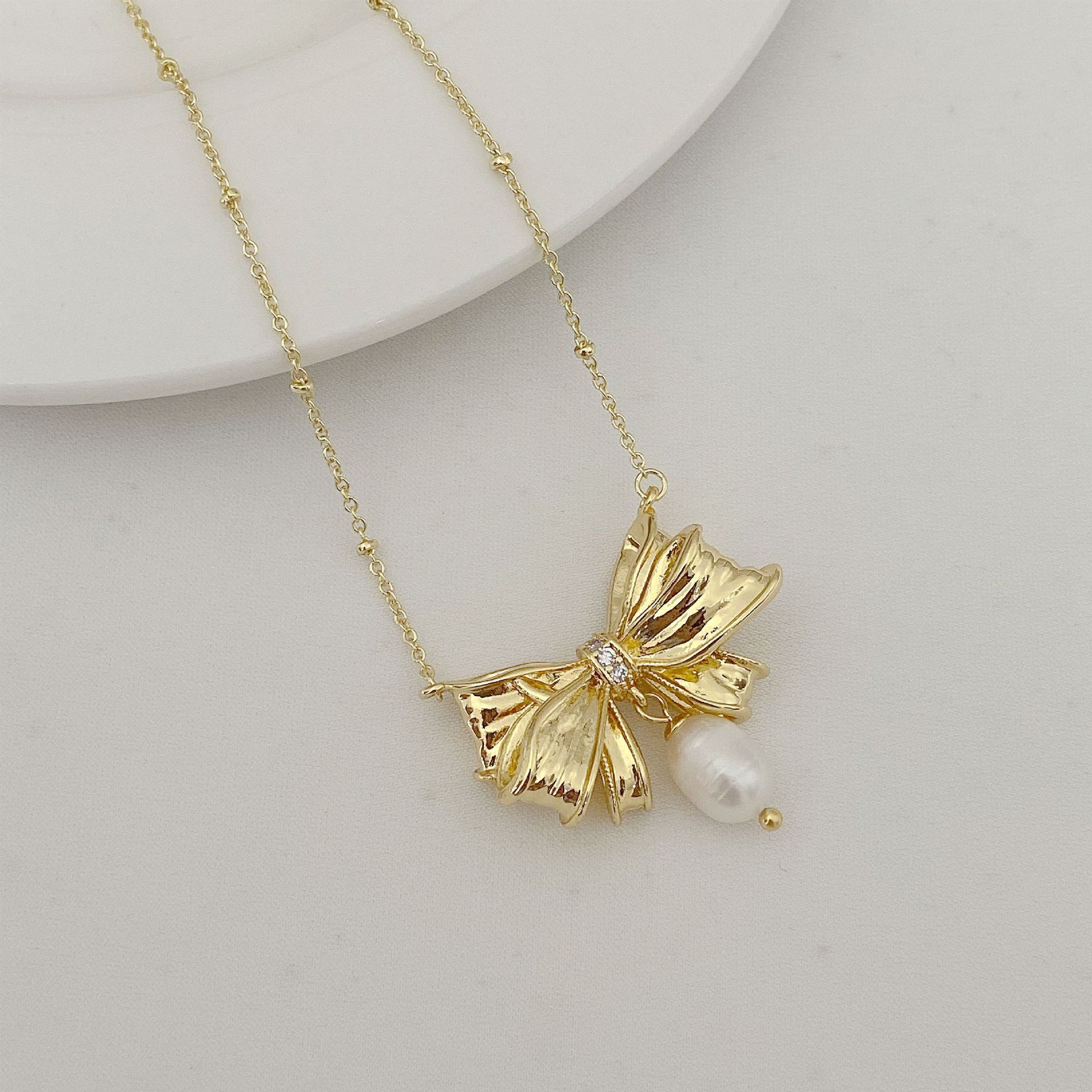 Fashionable pendant for St. Valentine's Day with bow pearl
