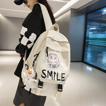 跨境外貿學生雙肩包韓版可愛笑臉情侶背包大容量翻蓋背包一件代發