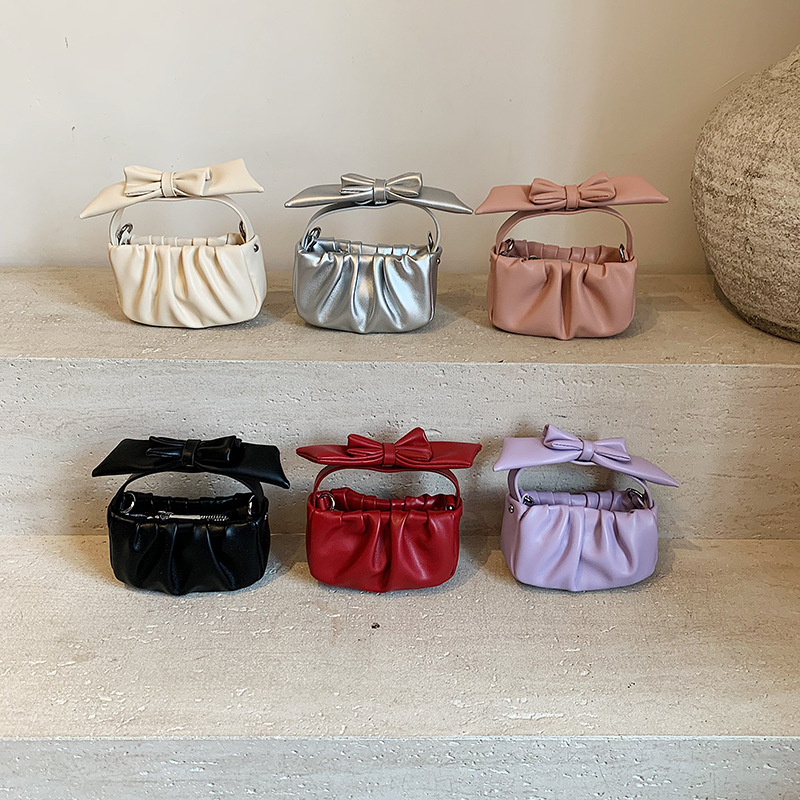Versión coreana del bolso de nube de niña de color sólido simple estilo occidental pliegue lindo lazo bolso de bebé nuevo bolso para niños