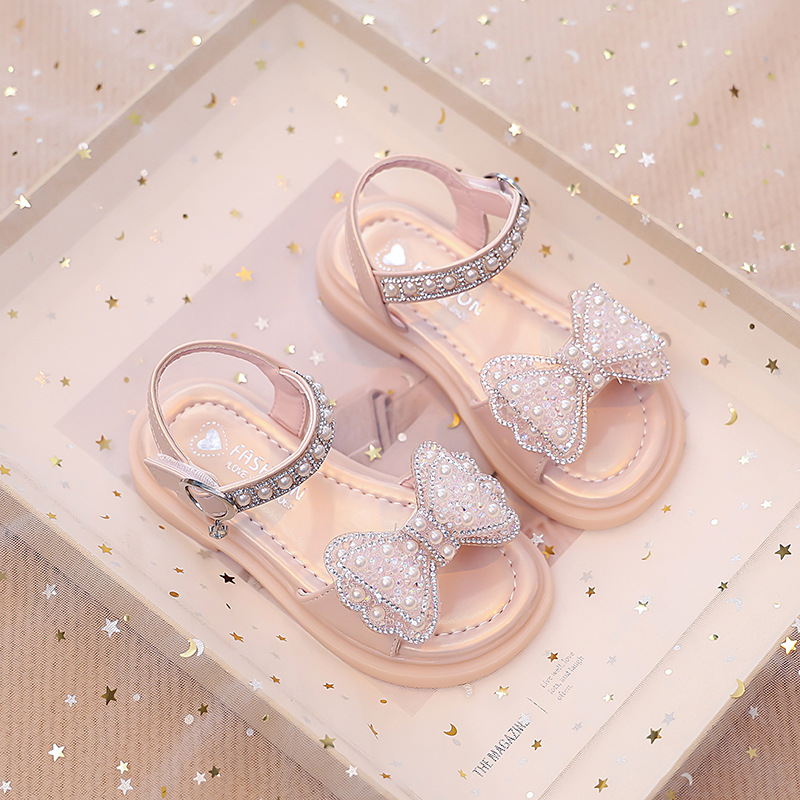 Niños verano 2026 nuevas sandalias de niñas arco brillante con base suave princesa sandalias de viento para niñas sandalias