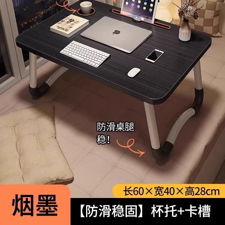 折り畳み可能なベッドの上の小さなテーブルは机のノートパソコンのテーブルを勉強します。|undefined