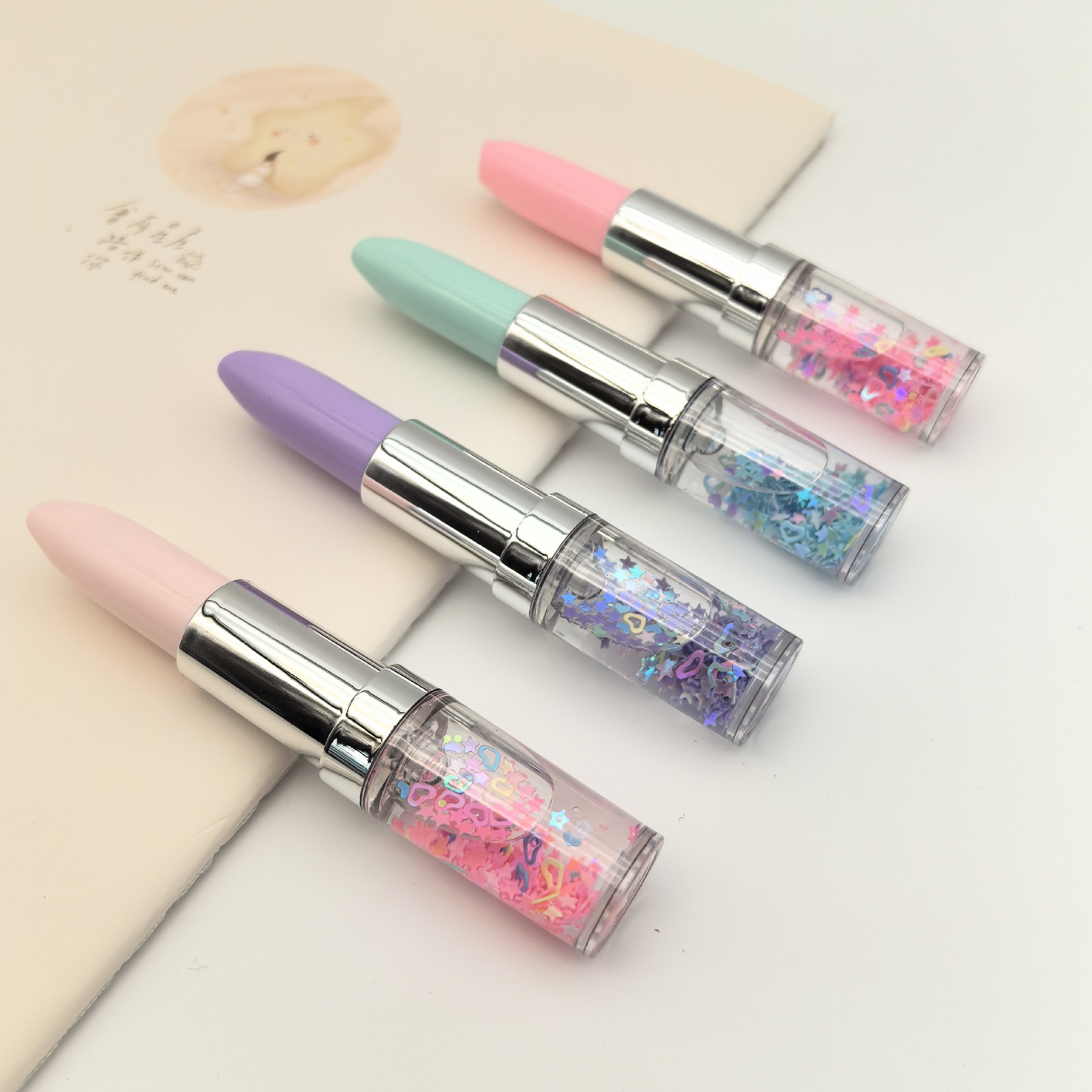 Fábrica de suministro directo de arena flotante sequinilla lápiz labial PVC lápiz labial estilo lápiz de bola japonés coreano lindo papelero conjunto lápiz