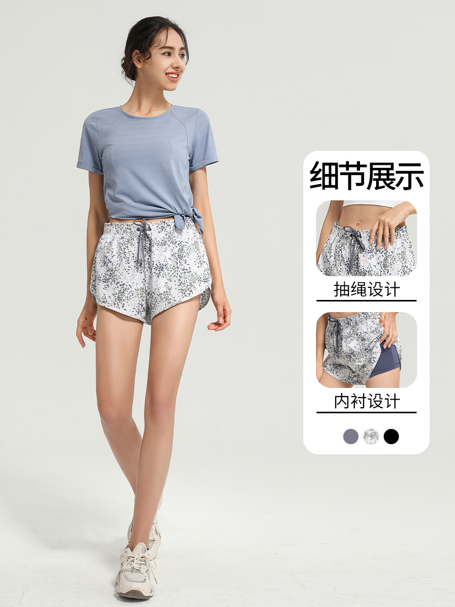 Nuevos pantalones cortos deportivos florales europeos y americanos anti-exposición de las mujeres falsos de dos piezas sueltos de secado rápido transpirable correr fitness yoga Pantalones