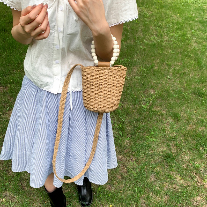 Bolso de cubo de vacaciones junto al mar 2025 nuevo bolso de mujer bolso de hombro de playa tejido de paja mini bolso de mensajero con cuentas