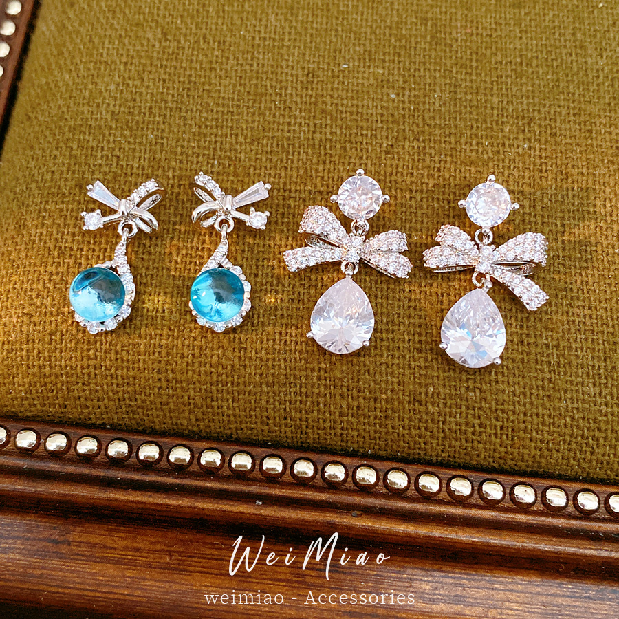 Aguja de plata zircon arco gotas de agua simple temperamento moda aretes de aretes ligeros de lujo alta sensación de aretes al por mayor