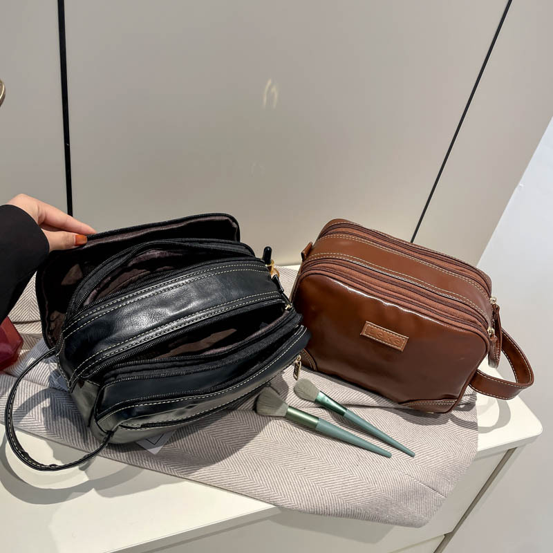 2025 nuevo paquete de lavado multicapa de gran capacidad, bolsas de maquillaje comerciales simples, bolsas de almacenamiento multifuncionales para viajes de cuero pu