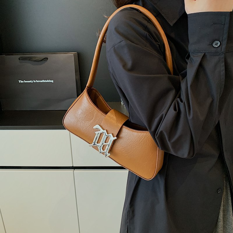 Bolso de palo francés retro francés 2025 nuevo bolso femenino de diseño popular de nicho con textura salvaje bolso de axila portátil de un solo hombro