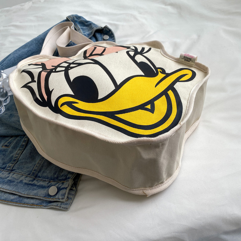 Bolsa de lona para mujeres versión coreana del pato Donald 2025 nueva tarjeta de ocio de gran capacidad bolsa de compras para mujeres de mano