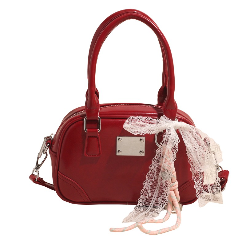 Bolsa de bolos portátil coreana de nicho para mujeres 2026 nueva textura mochila de hombro de estilo extranjero para viajar simple