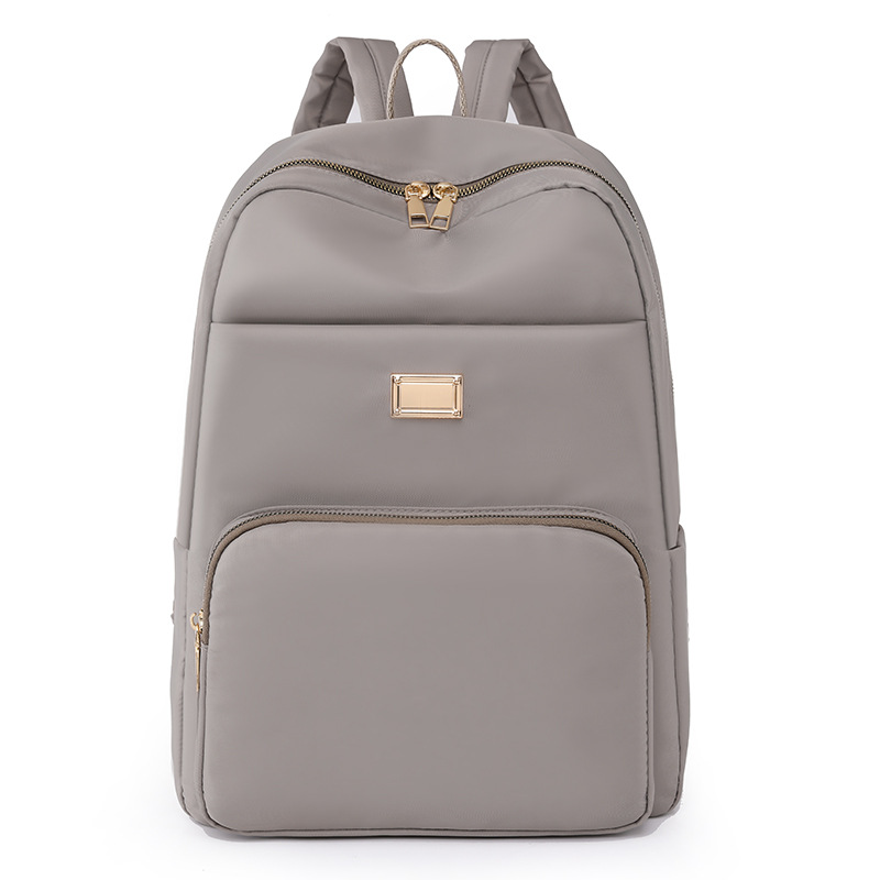 Comercio exterior al por mayor 2023 verano nuevo estilo versión coreana de las señoras mochila de nailon mochila simple de color sólido de gran capacidad para estudiantes