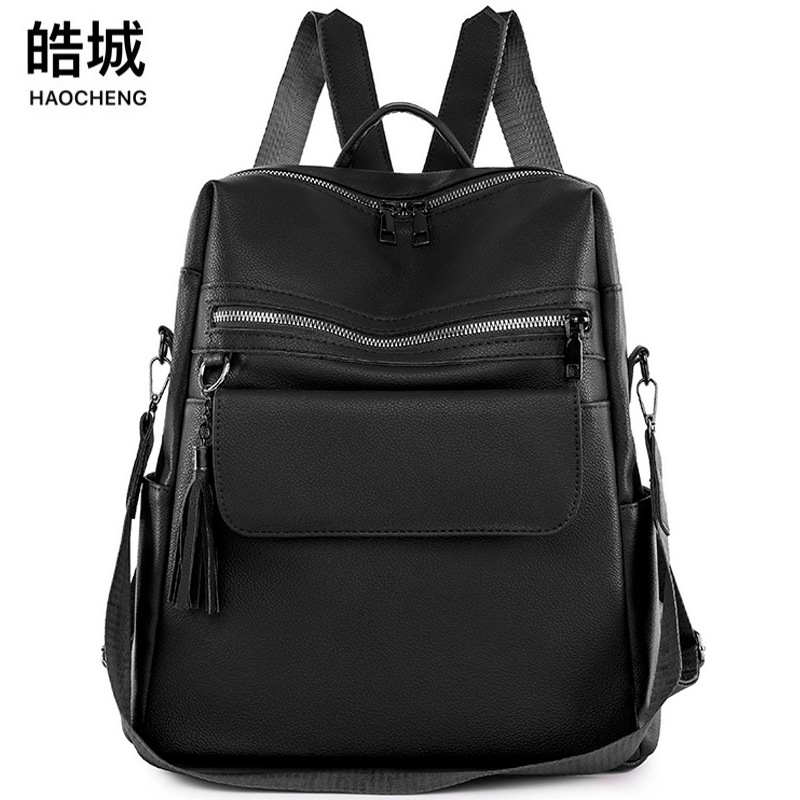 2024 nueva mochila de PU de moda casual para mujer, borla de moda, mochila de viaje de color sólido de gran capacidad al por mayor