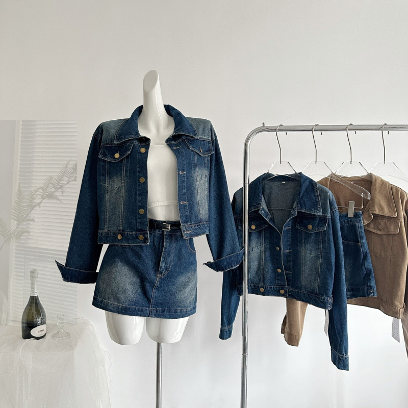 Easy-to-wear, relaxed denim, sexy, washed blue cotton soft and relaxed self-adjusting denim jacket and skirt set for women.