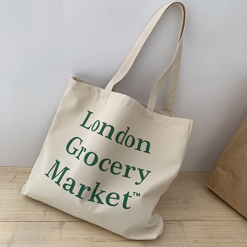 Bolsa de compras de lona de gran capacidad estilo europeo nuevo 2025 estilo ins perezoso para mujer, bolso de hombro para estudiantes, literario y simple.