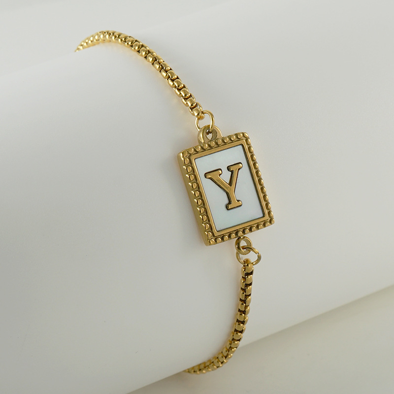 Nuevo europeo y americano transfronterizo de acero inoxidable 26 letras inglesas Shell pulsera personalidad todo partido titanio acero 18K cremallera