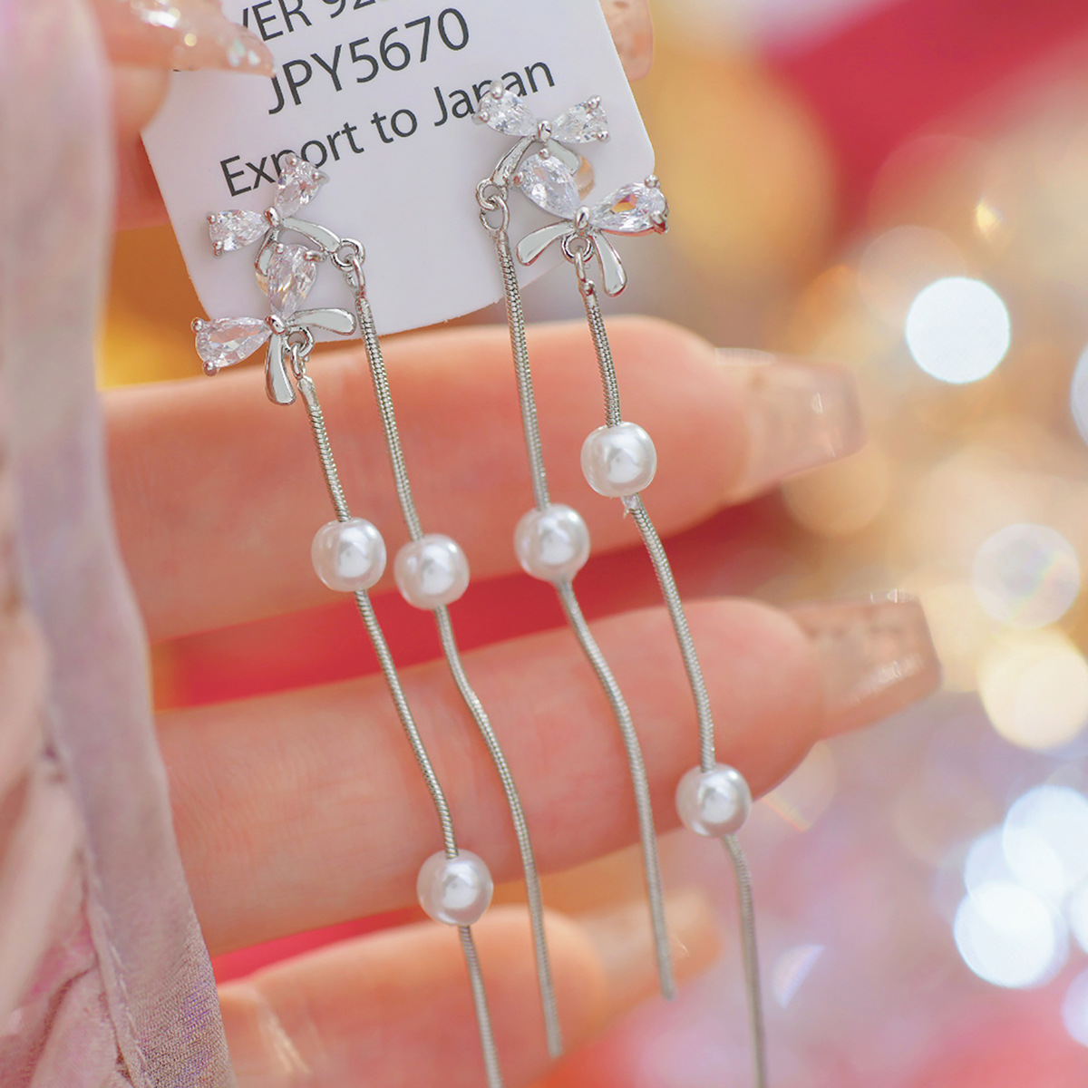 Sophisticated small design earrings with bow pearl with tassels with…