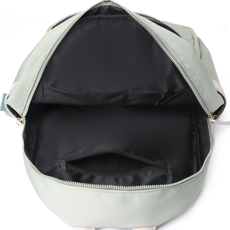Bolsos para mujer 2023 nueva mochila de nailon para mujer coreana moda contraste color remache mochila de viaje mochila escolar en nombre del cabello