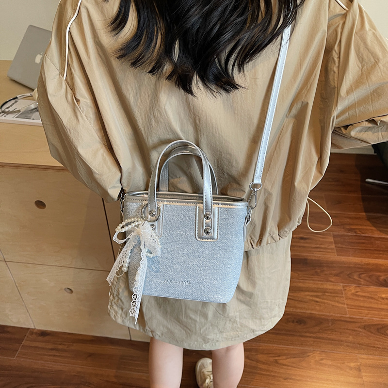 Bolso de cubo de mano de estilo occidental de moda para mujer 2025 nuevo bolso de hombro de todo fósforo de color de contraste bolso de mensajero de viaje de textura de moda