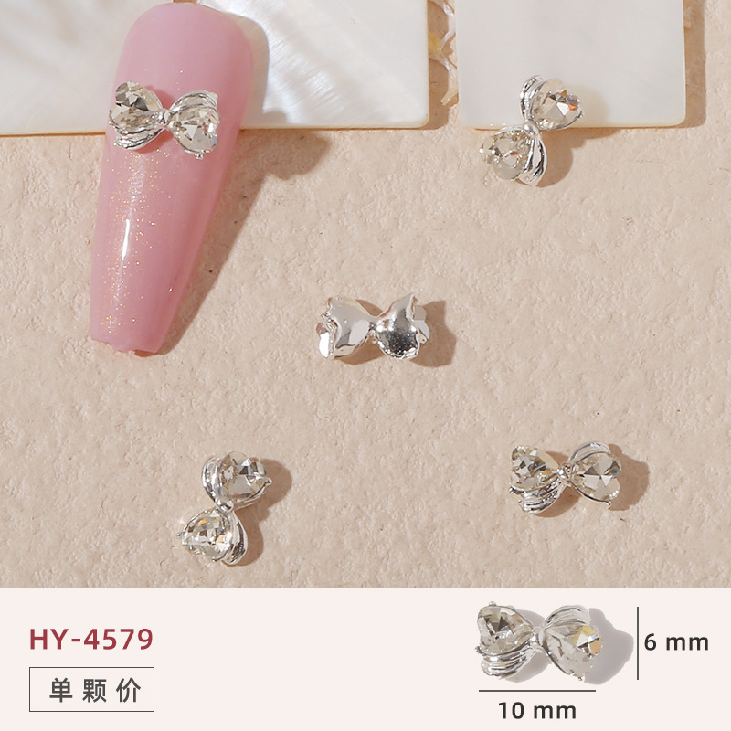 Uñas mariposa joyería nueva línea popular perla arco metal decoración de uñas pequeños accesorios de joyería al por mayor