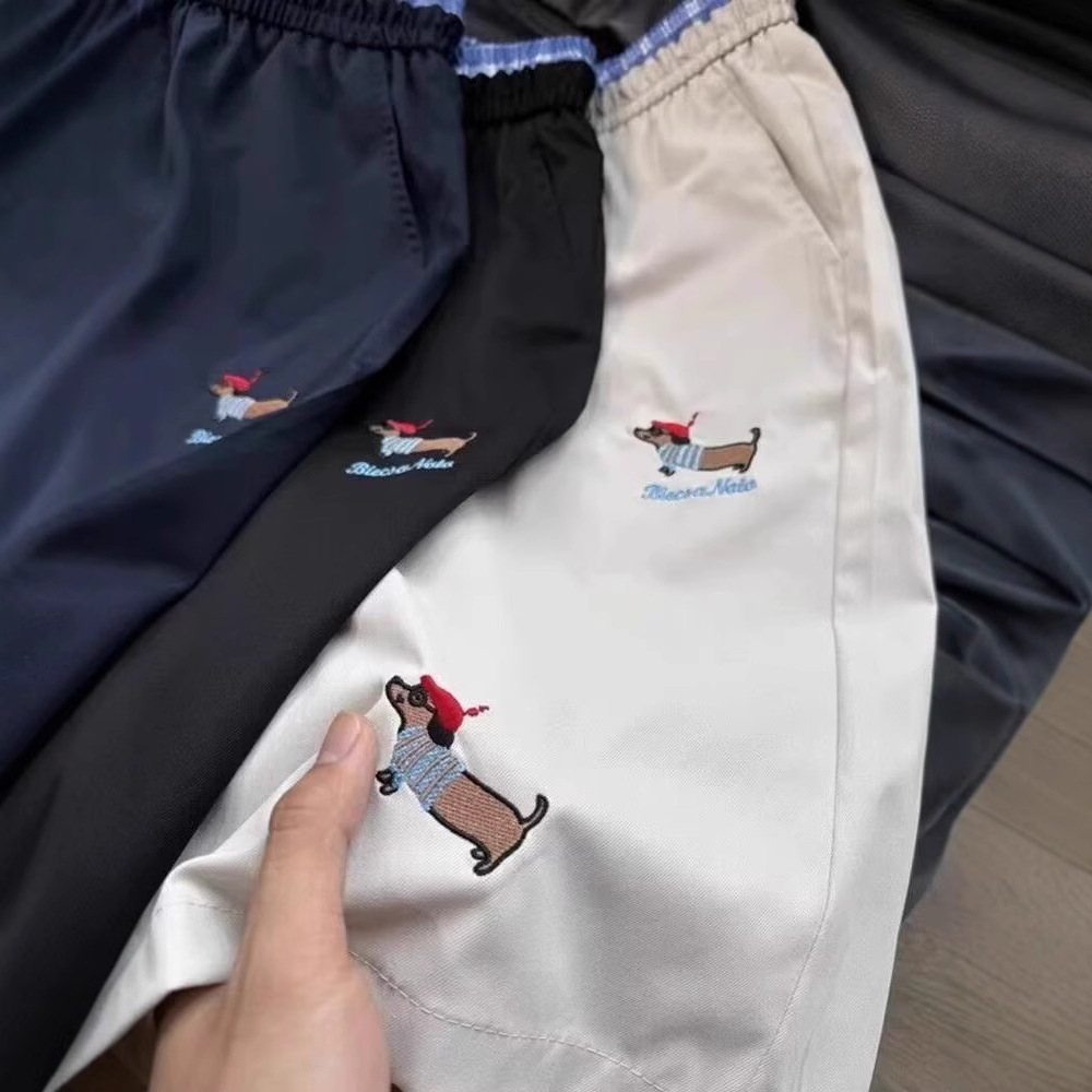 Pantalones casuales bordados de verano tendencia masculina sueltos más grandes pantalones de estilo de salchicha para hombres