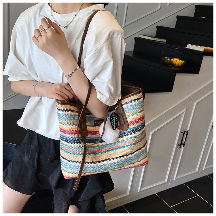 This is a new 2025 summer beach-style women's bag with a simple and versatile hand-held design. It's a single-shoulder vacation woven bag undefined
