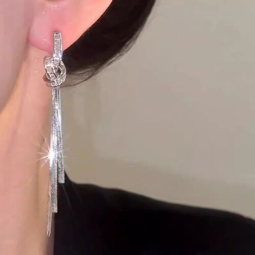 A long flowing tassel earring with a knotted rope, no piercing earring clip for women, mosquito coil plate design sense, exaggerated earring.