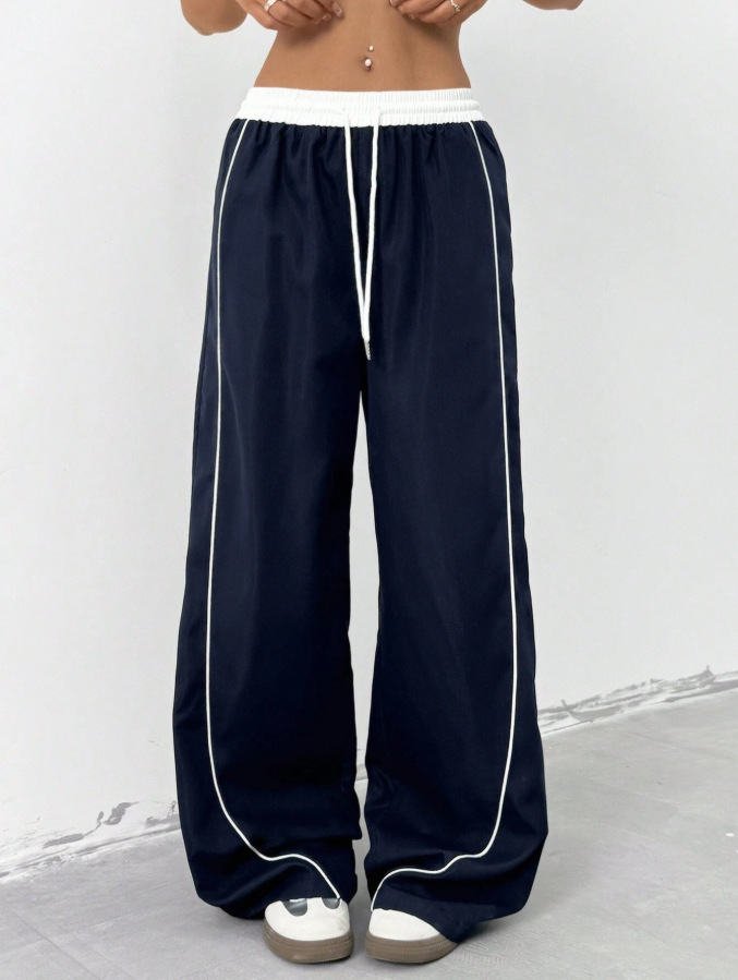 Europa y los Estados Unidos transfronterizos de otoño y invierno 2025 moda nuevos pantalones deportivos negros de mujer sueltos ociosos nichos de piernas largas