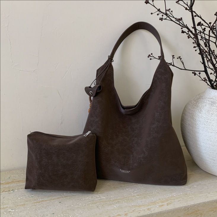 Transfronterizos de gran capacidad perezosa bolsa de viento para mujeres otoño / invierno 2025 nuevo retro moda brazalete nicho bolso de hombro