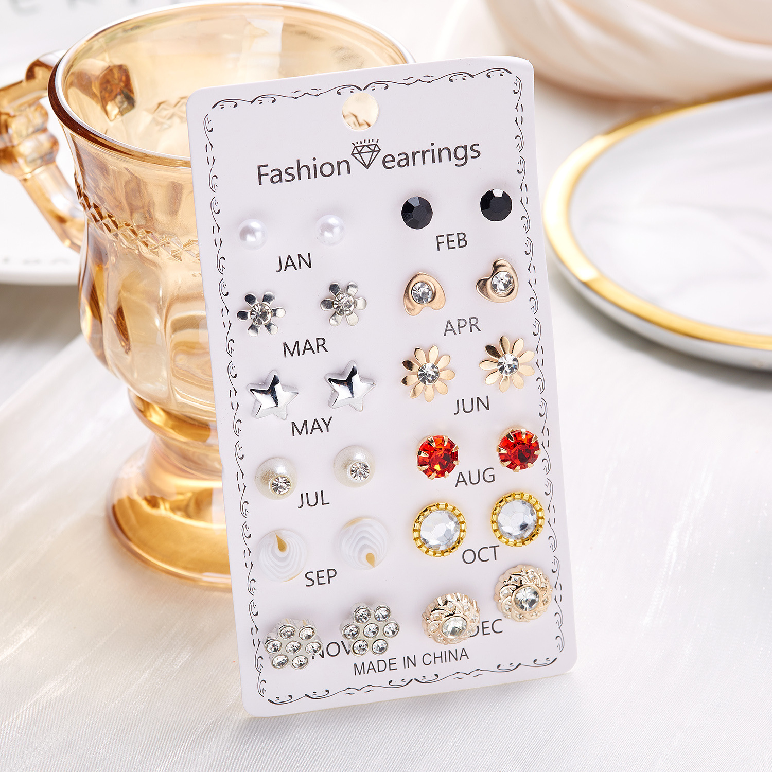 Set de 12 pares de aretes con flores de diamante