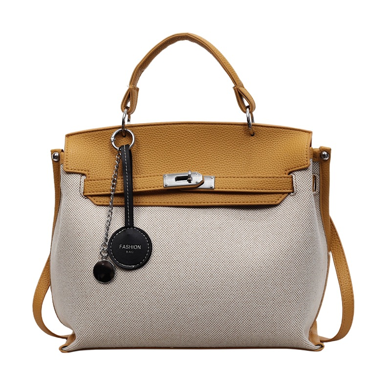 Bolso para mujeres 2026 nuevo cross-border lienzo empalme color contraste bolso de mano alta sensación retro mochila de hombro