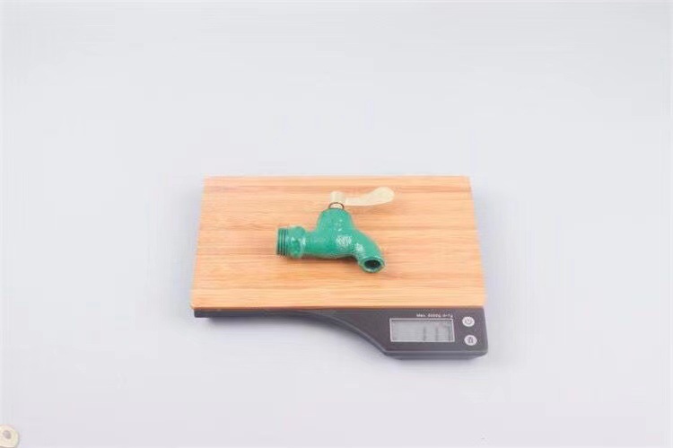Old-fashioned iron faucet with a slow opening time of 4 minutes or 6 minutes and a fast opening time. It is a copper core flat spout cast iron faucet with a key at an outdoor construction site undefined