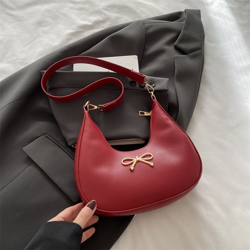 Sensación de la axila bolso pequeño mujer 2025 primavera nueva moda todo-fósforo bolso de hombro diseño de nicho bolso de palo francés mujer